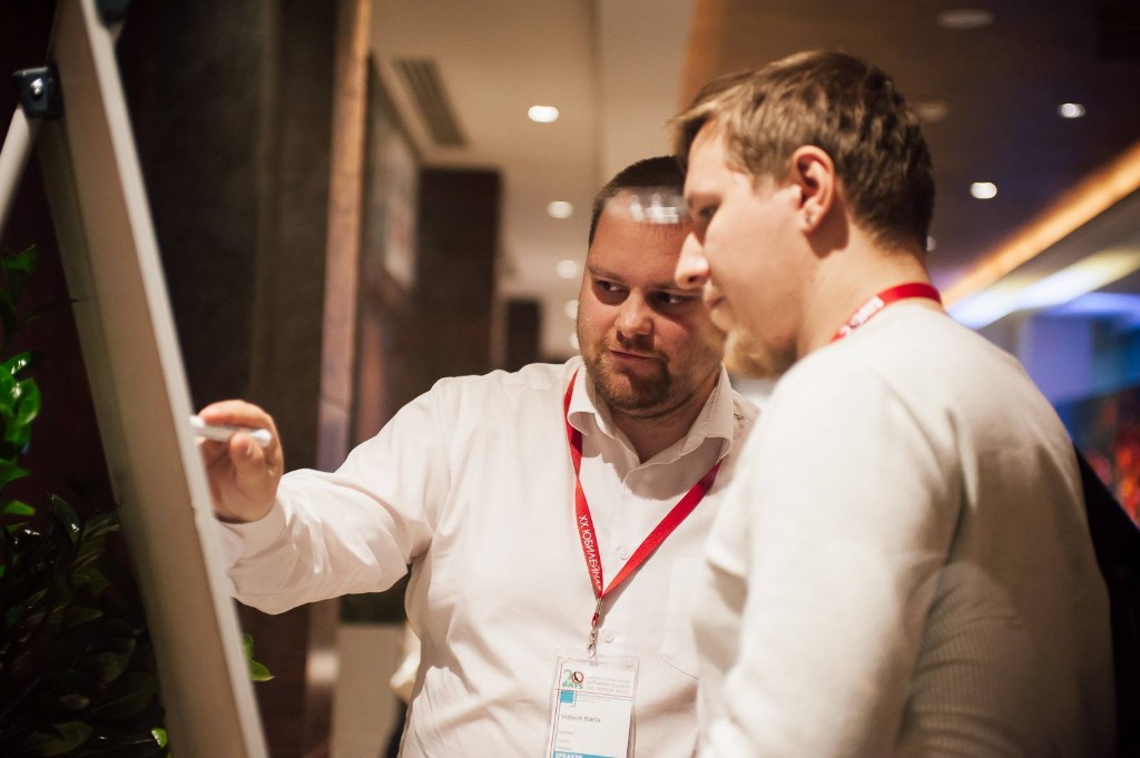 Speaker at a whiteboard with a colleague during a conference session