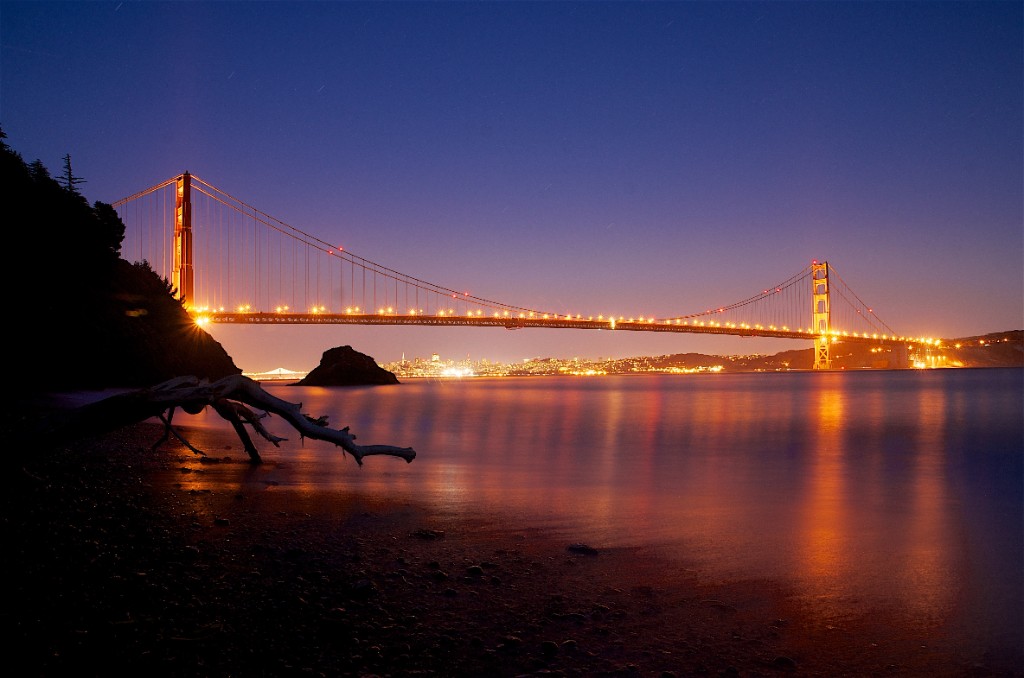 Golden Gate Bridge at night with long exposure reflections on the bay