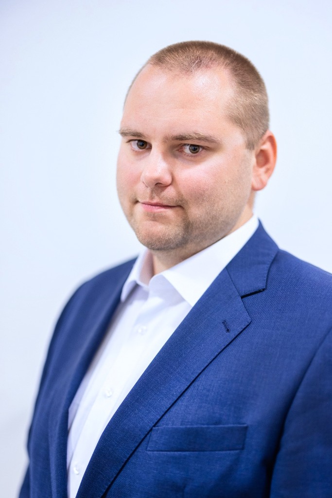 Professional headshot of Vojtěch Barta wearing a blue blazer and white shirt.